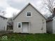 Rear exterior of a house with neutral siding and a small porch, surrounded by a yard at 1553 W New York St, Indianapolis, IN 46222