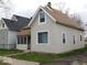Side view of home featuring neutral siding and a charming screened-in porch at 1553 W New York St, Indianapolis, IN 46222