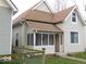 Street view of a cozy home featuring neutral siding and a covered front porch at 1553 W New York St, Indianapolis, IN 46222