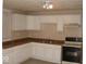 Kitchen with white cabinets, laminate countertops, and classic appliances at 1553 W New York St, Indianapolis, IN 46222