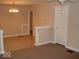 Inviting living room with tile and carpet flooring, chandelier, and neutral color scheme at 1553 W New York St, Indianapolis, IN 46222