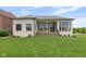 Spacious backyard featuring a white brick home with large windows and a well-maintained lawn at 16512 Grand Cypress Dr, Noblesville, IN 46060