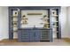 Stylish basement bar with open shelving, granite countertop, and a wine refrigerator at 16512 Grand Cypress Dr, Noblesville, IN 46060