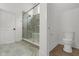 Modern bathroom features a glass shower, tiled walls, and a toilet for a sleek and functional space at 16512 Grand Cypress Dr, Noblesville, IN 46060