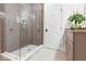 Modern bathroom features a glass shower, granite vanity, and neutral color palette at 16512 Grand Cypress Dr, Noblesville, IN 46060