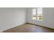 A bright, empty bedroom with large window showing a view of the neighborhood at 16512 Grand Cypress Dr, Noblesville, IN 46060