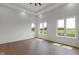 Bright bedroom with hardwood floors and ample natural light from three large windows overlooking a green field at 16512 Grand Cypress Dr, Noblesville, IN 46060