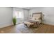 Bright bedroom with neutral décor, wood floors, a large window, and stylish furnishings at 16512 Grand Cypress Dr, Noblesville, IN 46060