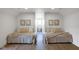 Cozy bedroom featuring two beds with neutral linens and decor with hardwood floors at 16512 Grand Cypress Dr, Noblesville, IN 46060