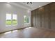 Inviting bedroom with hardwood floors, decorative wall, and large windows overlooking the lush green exterior at 16512 Grand Cypress Dr, Noblesville, IN 46060