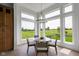 Bright dining area with natural light, a modern chandelier, and picturesque backyard views at 16512 Grand Cypress Dr, Noblesville, IN 46060