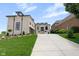 Elegant brick home featuring a three-car garage, landscaped yard and a large concrete driveway at 16512 Grand Cypress Dr, Noblesville, IN 46060