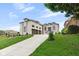 Gorgeous brick home with manicured lawn, rock landscaping and an expansive concrete driveway leading to a 3-car garage at 16512 Grand Cypress Dr, Noblesville, IN 46060