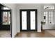 Elegant foyer showcasing ornate double doors with decorative glass, hardwood floors and sophisticated architectural design at 16512 Grand Cypress Dr, Noblesville, IN 46060