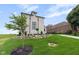 Beautifully landscaped yard featuring a retaining wall made of rocks, green grass and manicured landscaping at 16512 Grand Cypress Dr, Noblesville, IN 46060