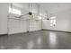 Bright garage with epoxy floors, overhead door, and windows, offering ample space for parking and storage at 16512 Grand Cypress Dr, Noblesville, IN 46060