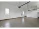 Clean, spacious garage with epoxy floors, windows, and overhead storage for organized functionality and lots of light at 16512 Grand Cypress Dr, Noblesville, IN 46060