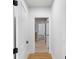 Bright hallway featuring white walls, wood flooring, and open doorways at 16512 Grand Cypress Dr, Noblesville, IN 46060
