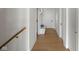 Bright hallway features hardwood floors, white walls, and a built-in bench at 16512 Grand Cypress Dr, Noblesville, IN 46060