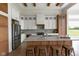 Elegant kitchen featuring marble countertops, a kitchen island with seating, stainless steel appliances, and custom cabinetry at 16512 Grand Cypress Dr, Noblesville, IN 46060