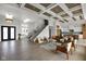 Spacious living room with coffered ceilings, hardwood floors, a staircase and an open floor plan to the kitchen at 16512 Grand Cypress Dr, Noblesville, IN 46060