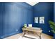 Elegant home office with stylish blue walls, decorative wainscoting, and a contemporary desk at 16512 Grand Cypress Dr, Noblesville, IN 46060