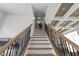 Beautiful stairway with iron spindles, wooden handrail and stairs with natural light at 16512 Grand Cypress Dr, Noblesville, IN 46060