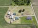Aerial view of farm with cultivated field, multiple buildings, silos, and mature trees at 17550 N 200 W, Summitville, IN 46070