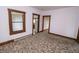 Cozy bedroom with patterned carpeting, featuring a window with blinds and doorways to adjoining spaces at 17550 N 200 W, Summitville, IN 46070