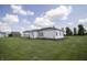 Exterior view of white sided home with a barn in the background at 17550 N 200 W, Summitville, IN 46070