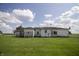 Exterior view of the back of a white sided home with lawn at 17550 N 200 W, Summitville, IN 46070