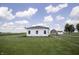Exterior view of white sided home with shed and barn in background at 17550 N 200 W, Summitville, IN 46070