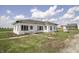 Exterior view of white sided home with a barn in the background at 17550 N 200 W, Summitville, IN 46070