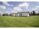 Exterior view of the back of a white sided home with a barn in background at 17550 N 200 W, Summitville, IN 46070