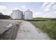 Exterior view of grain silos surrounded by a gravel lot, useful for agriculture, storage and development at 17550 N 200 W, Summitville, IN 46070