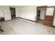 Partly renovated kitchen space with wooden trim, outdated tile flooring, and open doorways ready for upgrades at 17550 N 200 W, Summitville, IN 46070