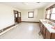 Bright kitchen area with wooden cabinets, retro tile, and a sunlit window for a charming, yet outdated, look at 17550 N 200 W, Summitville, IN 46070