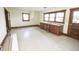 Sunlit kitchen with wooden cabinetry, outdated tile flooring, and a charming retro feel ready for renovation at 17550 N 200 W, Summitville, IN 46070