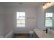 Bright bathroom featuring modern fixtures, including a combination shower and tub with window views at 1817 Real St, Indianapolis, IN 46240