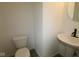 Simple half-bathroom with pedestal sink and toilet providing essential functionality and space efficiency at 1817 Real St, Indianapolis, IN 46240