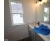Modern bathroom features a sleek vanity with a stone countertop and a bright window at 1817 Real St, Indianapolis, IN 46240