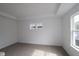 Spacious bedroom featuring tray ceilings and large windows offering natural light at 1817 Real St, Indianapolis, IN 46240
