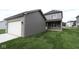 Exterior showcasing a garage, grey siding, and green lawn that enhances its curb appeal at 1817 Real St, Indianapolis, IN 46240