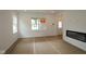 Bright, unfinished living room with fireplace and ample natural light from the windows at 1817 Real St, Indianapolis, IN 46240