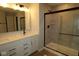 Modern bathroom featuring double vanity with sleek fixtures, and a glass-enclosed shower for a spa-like experience at 1821 Real St, Indianapolis, IN 46240