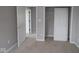 This carpeted bedroom has a closet, neutral walls, white trim and a view to another room at 1821 Real St, Indianapolis, IN 46240