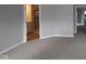 This bedroom is carpeted and has neutral walls, leading to bathroom and hallway at 1821 Real St, Indianapolis, IN 46240
