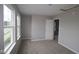 This bedroom features carpet, neutral walls, white trim and two large windows at 1821 Real St, Indianapolis, IN 46240
