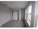 Cozy bedroom featuring plush carpeting, a closet, and ample natural light from the windows at 1821 Real St, Indianapolis, IN 46240