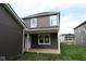This is a view of the backyard of a two-story home with green grass at 1821 Real St, Indianapolis, IN 46240